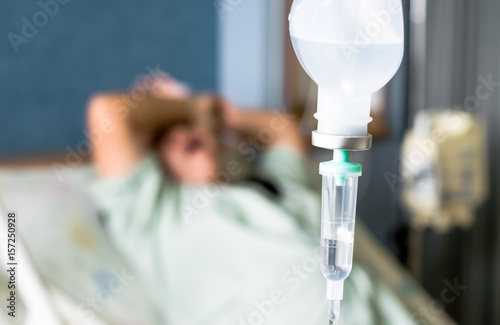 the saline IV drip over patient and Infusion pump in hospital