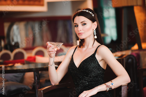 Portrait of beautiful woman holding glass of martini