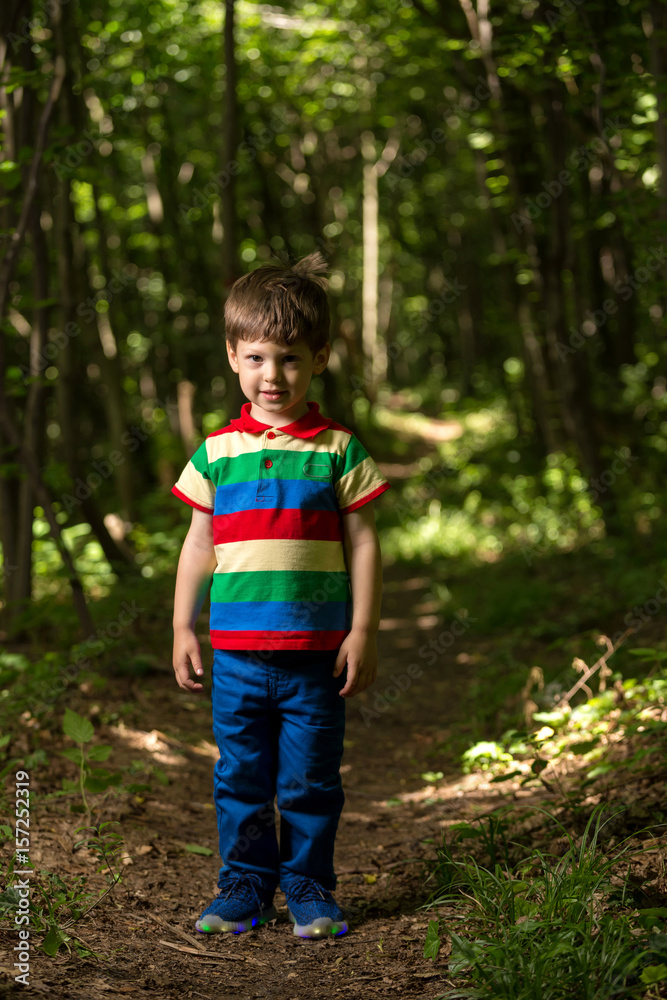 young boy playing in the green forest young boy playing in the green forest