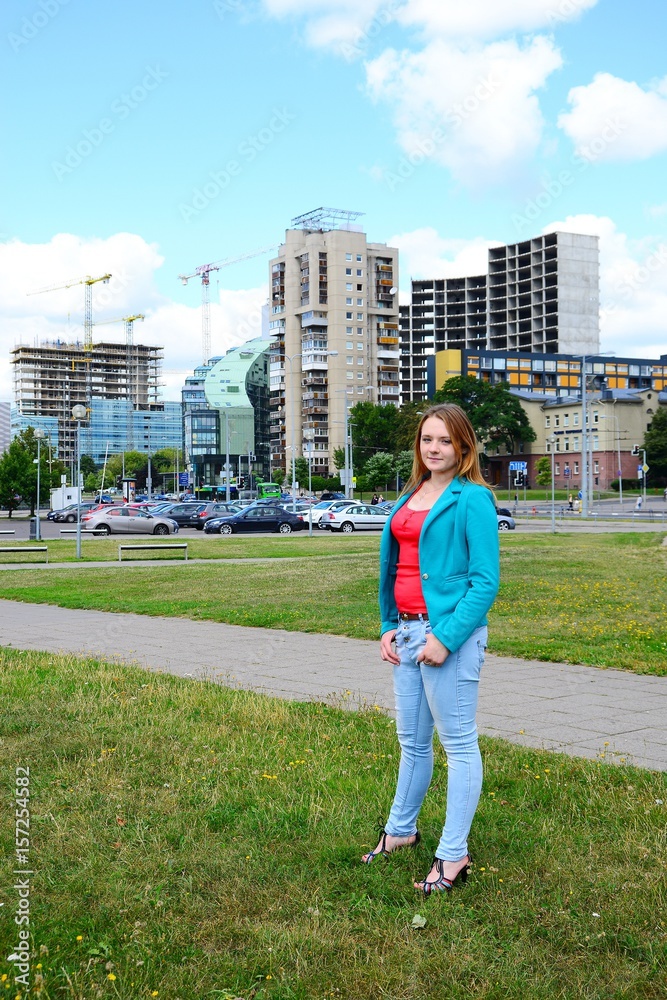 A girl in the city and blue sky and clouds background