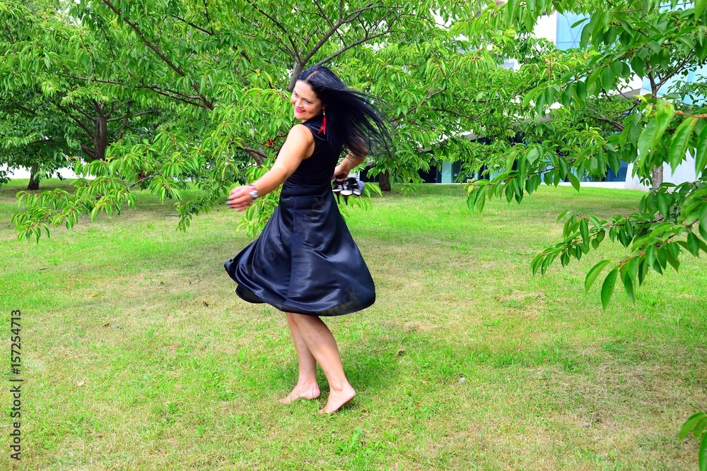 Woman in black in the Vilnius city sakura garden