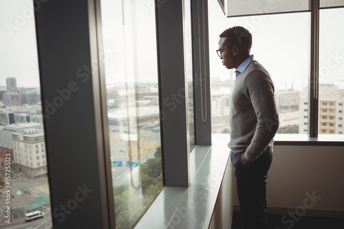 Thoughtful executive looking through window