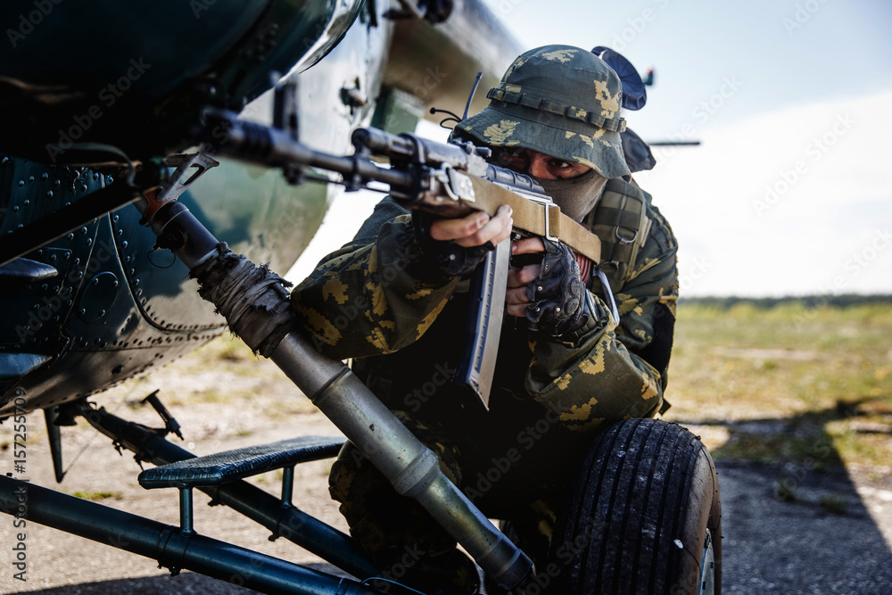 Photo of a soldier with an automatic rifle Photo of a soldier with an automatic rifle