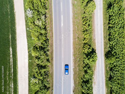 steet or country road with a blue car  photo