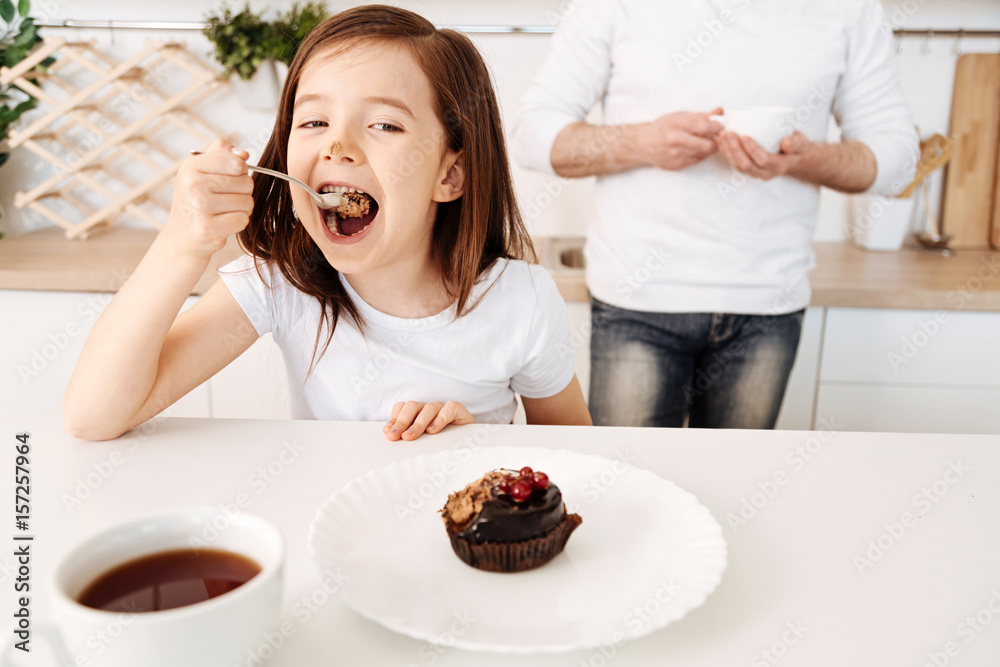 Little girl looking delighted with her cake Little girl looking delighted with her cake