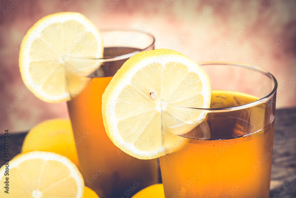 lemon ice tea on wooden table with lemons around lemon ice tea on wooden table with lemons around