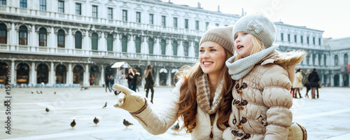 mother and daughter in Venice, Italy pointing at something