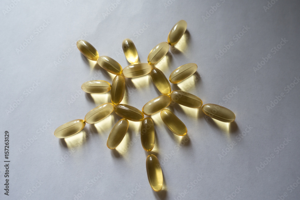 Evening primrose oil supplement capsules in a sun shape Evening primrose oil supplement capsules in a sun shape