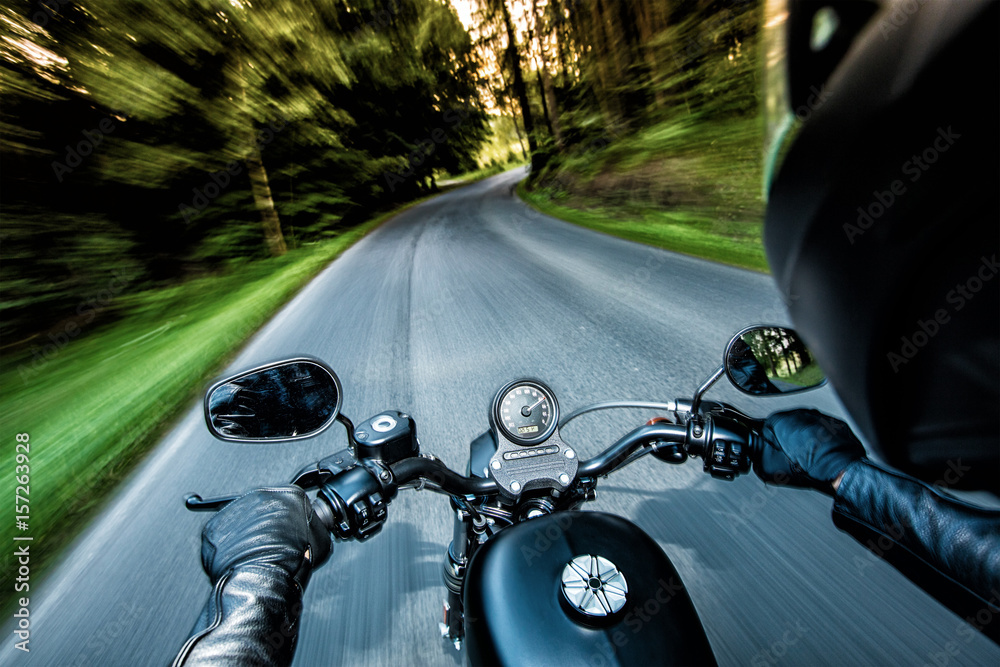 Fototapeta premium Man seat on the motorcycle on the forest road.