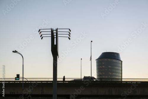 Urban silhouette of city bridge office building advertising billboard and traffic light