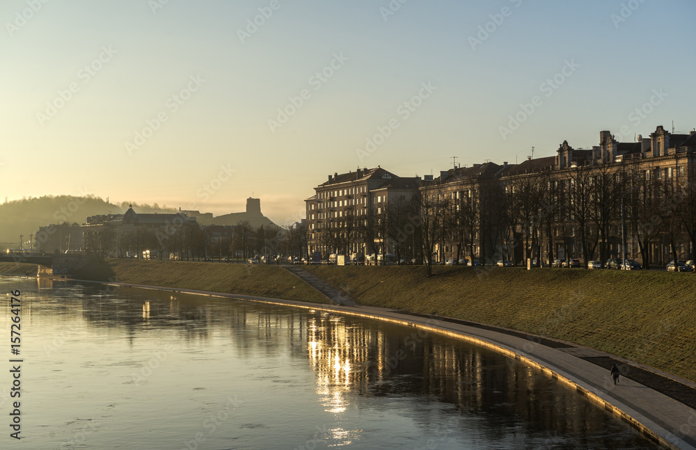 Vilnius old town sunrise on river reflection, Gediminas castle silhouette