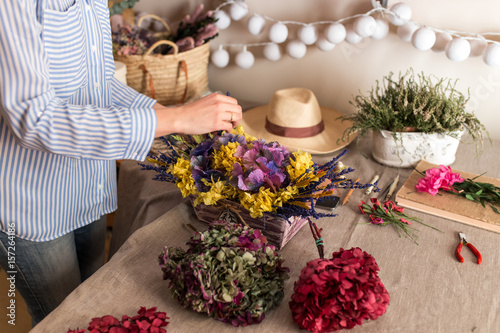 Crop woman arranging flowers photo