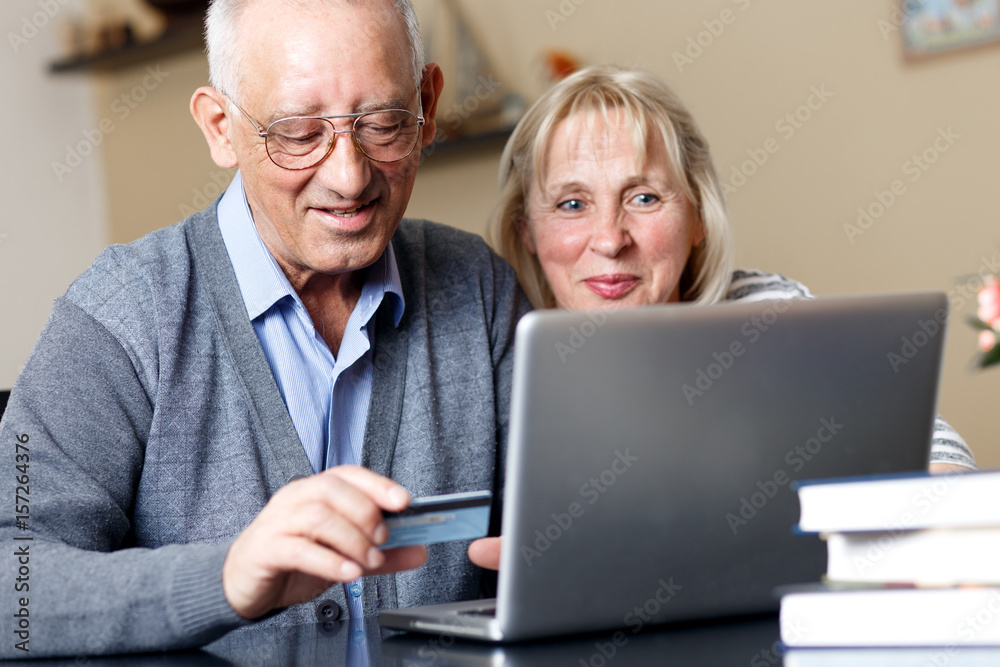 Senior couple, with laptop, shopping on line at home. Senior couple, with laptop, shopping on line at home.