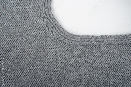 Sweater or scarf fabric texture large knitting. Knitted jersey background with a relief pattern. Wool hand- machine, handmade, gray.
