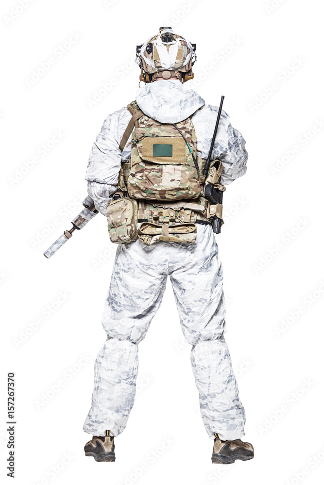 Fototapeta premium Special forces operator of Navy Seals armed with assault rifle with closed face in polarized sunglasses and military winter camo clothes designed to operations in extreme conditions. Studio shot