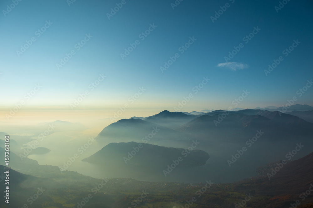Mountains in the fog in Punta Almana, Iseo Lake, Italy Mountains in the fog in Punta Almana, Iseo Lake, Italy
