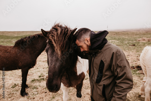 Man leaning on horse