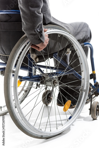 cropped shot of physically handicapped man on wheelchair isolated on white