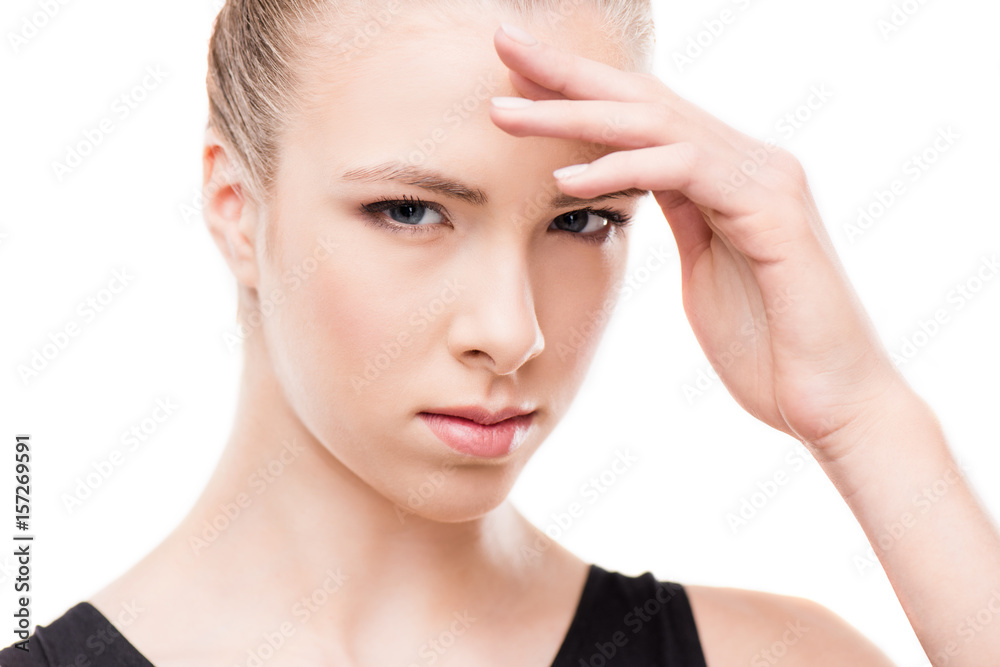 sad woman with headache touching her head and looking at camera isolated on white