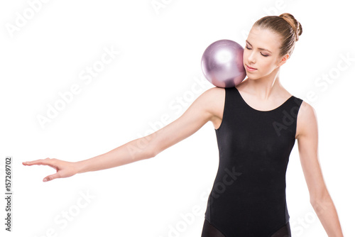 attractive rhythmic gymnast in leotard training with ball isolated on white