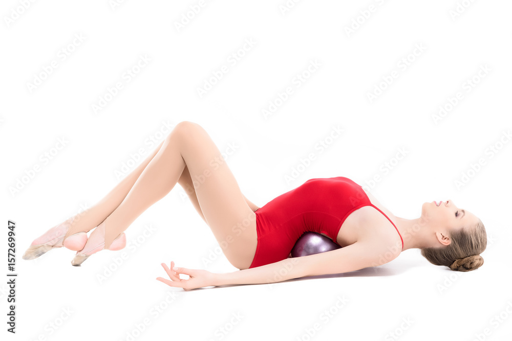 side view of rhythmic gymnast training with gym ball isolated on white side view of rhythmic gymnast training with gym ball isolated on white