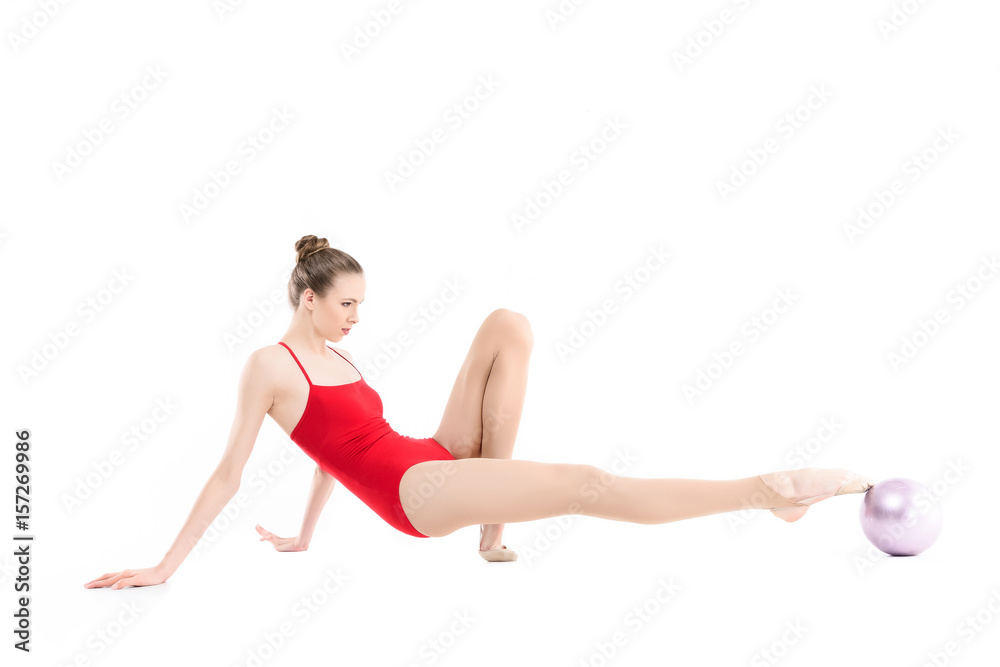 focused rhythmic gymnast exercising with ball isolated on white focused rhythmic gymnast exercising with ball isolated on white