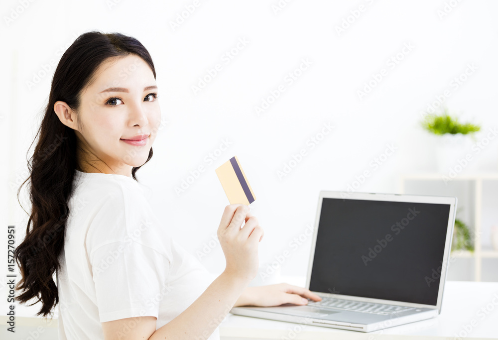 young smiling woman with laptop and credit card young smiling woman with laptop and credit card