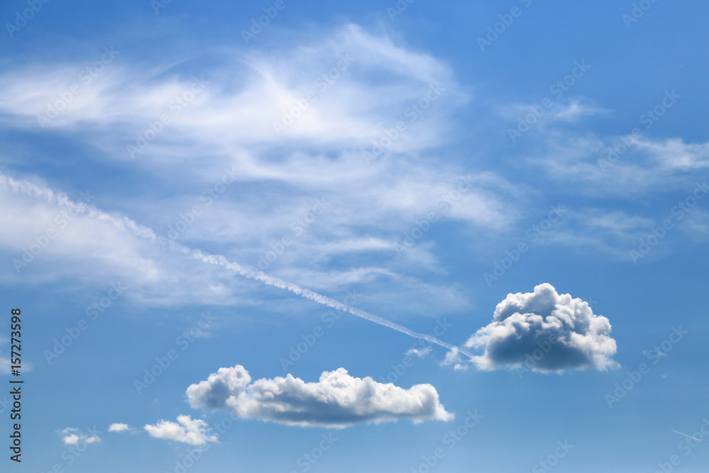 Blue sky with clouds and trail of plane Blue sky with clouds and trail of plane