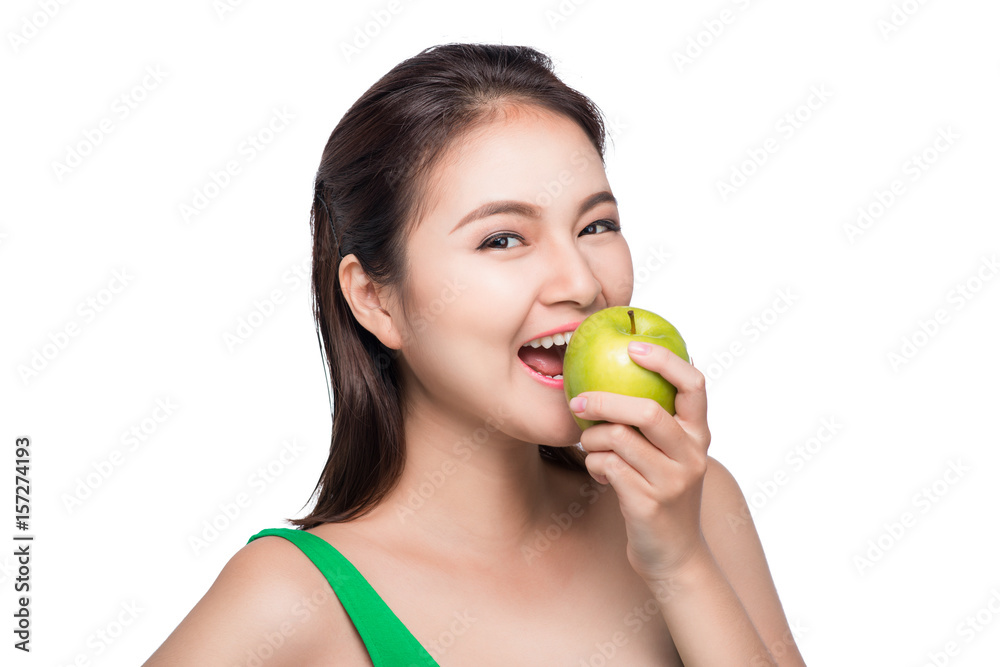 Young beautiful asian woman eating fresh green apple on white background Young beautiful asian woman eating fresh green apple on white background