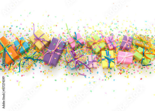 Colored gift boxes with colorful ribbons and confetti. White background. Gifts for Christmas or a birthday.