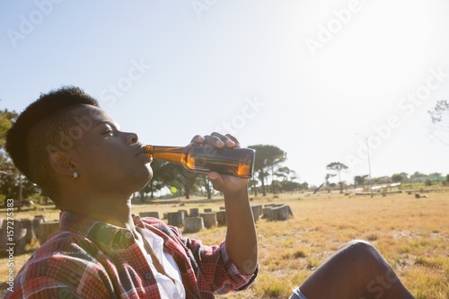 Young man having a beer in the park