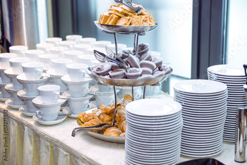 Catering table with dishes and snacks on the business event in the hotel hall. Close up, selective focus. photo