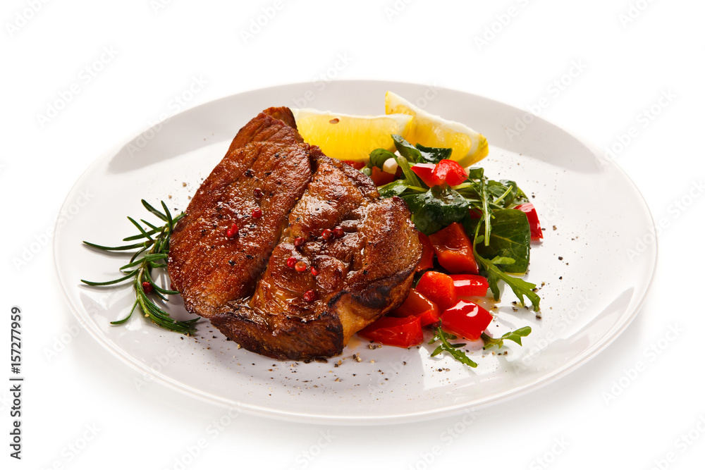 Grilled beefsteak with vegetables on white background Grilled beefsteak with vegetables on white background
