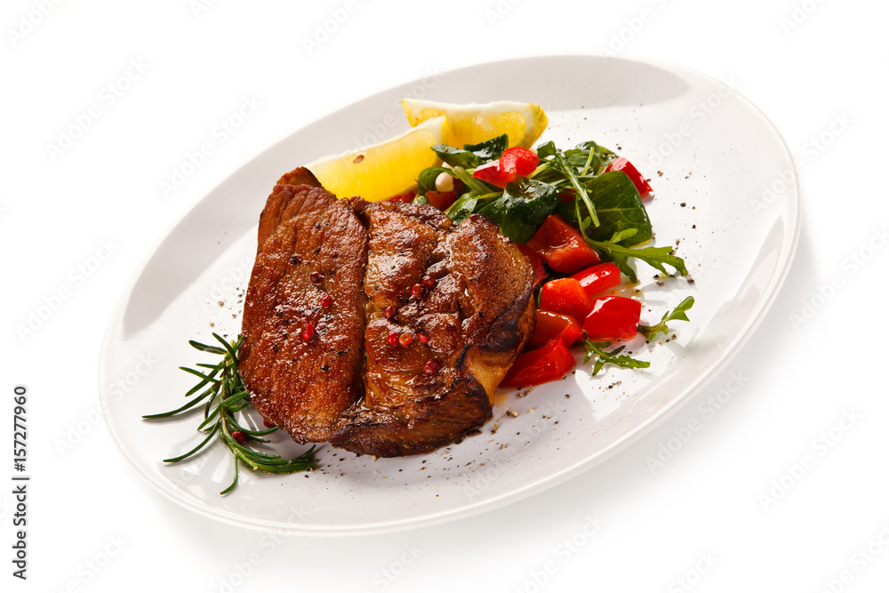 Grilled beefsteak with vegetables on white background