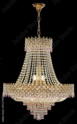 Large crystal chandelier in baroque style isolated on black background.