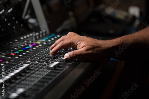 Hand of male audio engineer using sound mixer © WavebreakMediaMicro