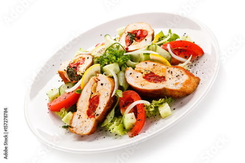 Salad with stuffed chicken fillet on white background