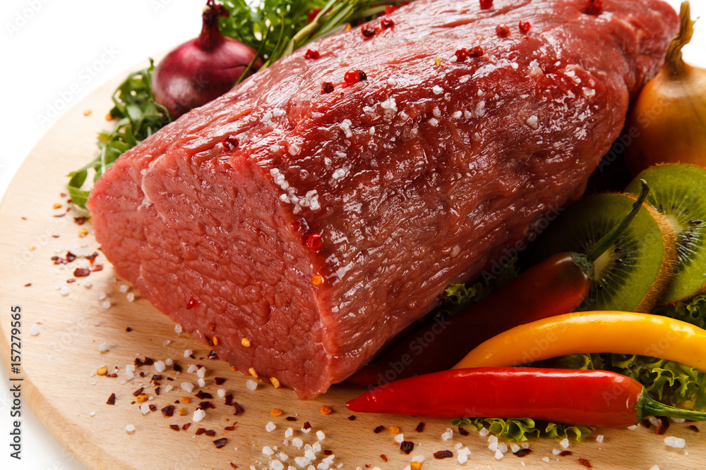 Fresh raw beef on cutting board on white background Fresh raw beef on cutting board on white background