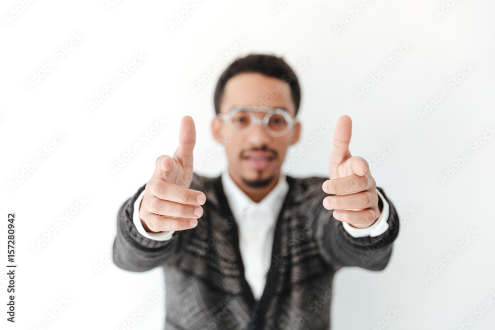 Handsome young african man pointing. Focus on hands. Handsome young african man pointing. Focus on hands.