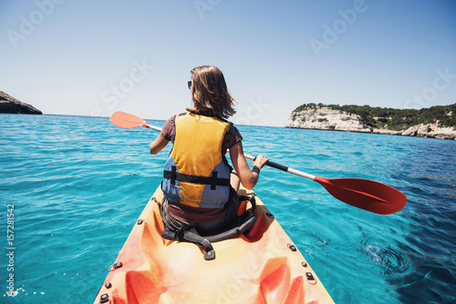 Young woman kayaking in the sea. Active lifestyle and travel concept