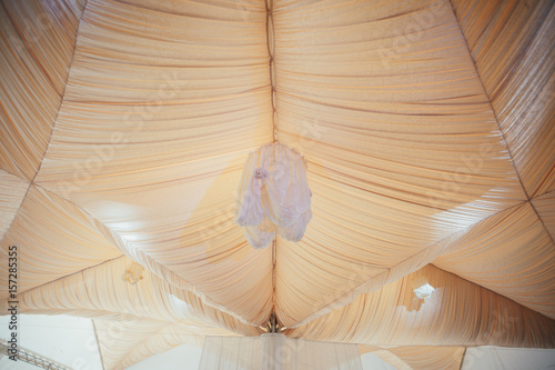 Lamp with white cloth hangs from the tent