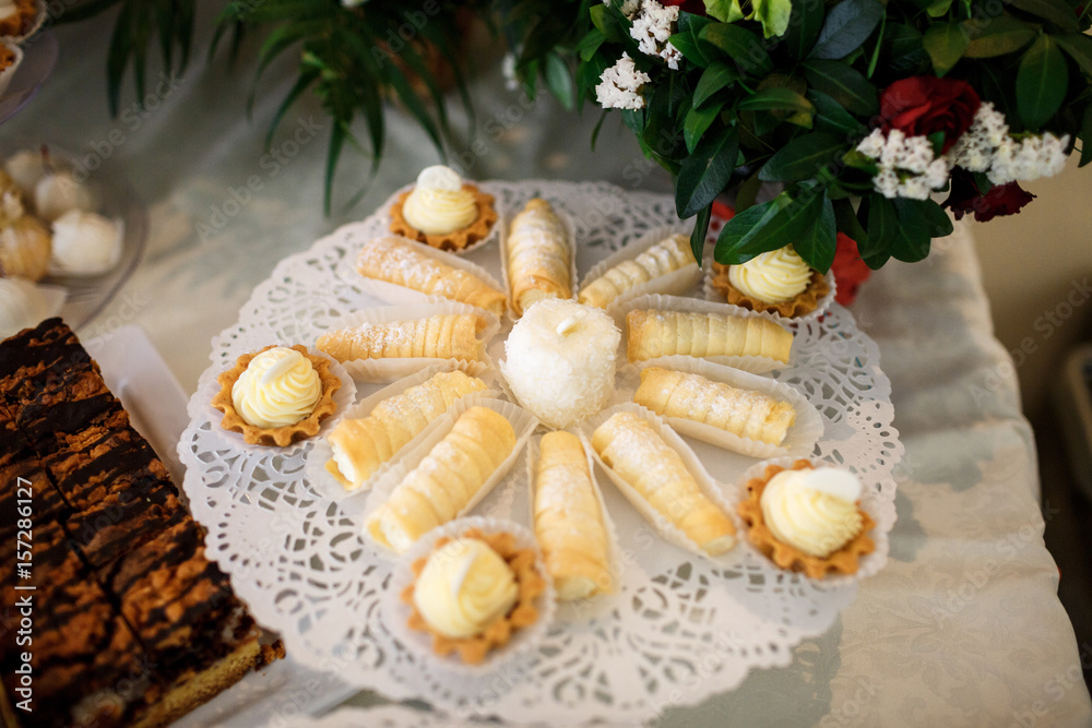 Cookies covered with white chocolate stand on a glass dish Cookies covered with white chocolate stand on a glass dish