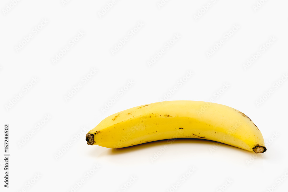 Ripe banana on white background - diet food concept with copy space Ripe banana on white background - diet food concept with copy space
