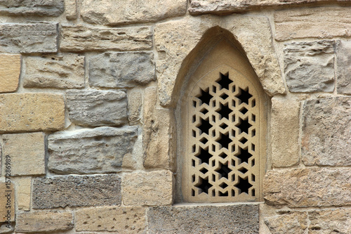 Arched window in stone wall of an old mosque  Baku  Azerbaijan