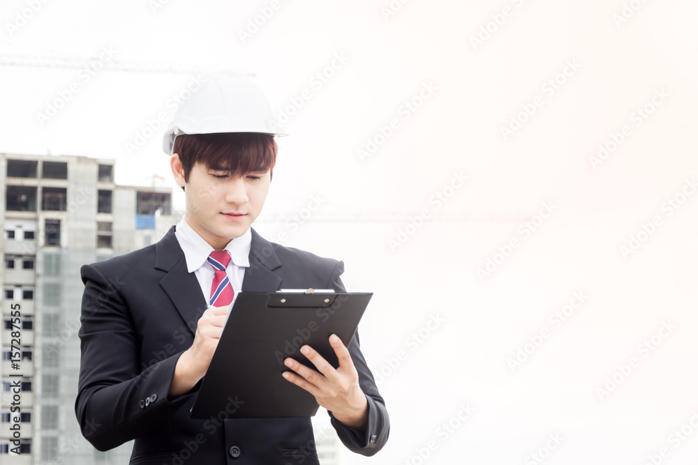 asian construction business man working on take note. asian construction business man working on take note.