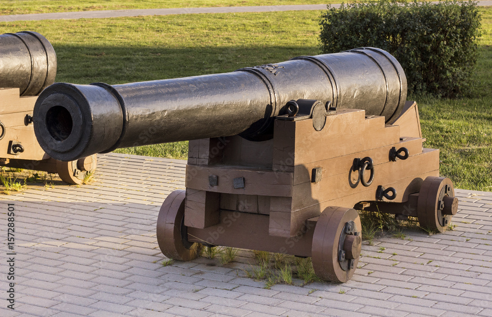 ancient historical gun on a wooden pedestal
