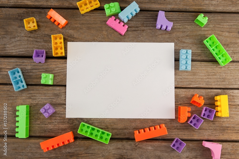 Blank paper amidst toy blocks on table Blank paper amidst toy blocks on table