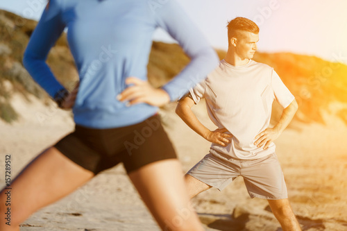 Young couple on beach training together