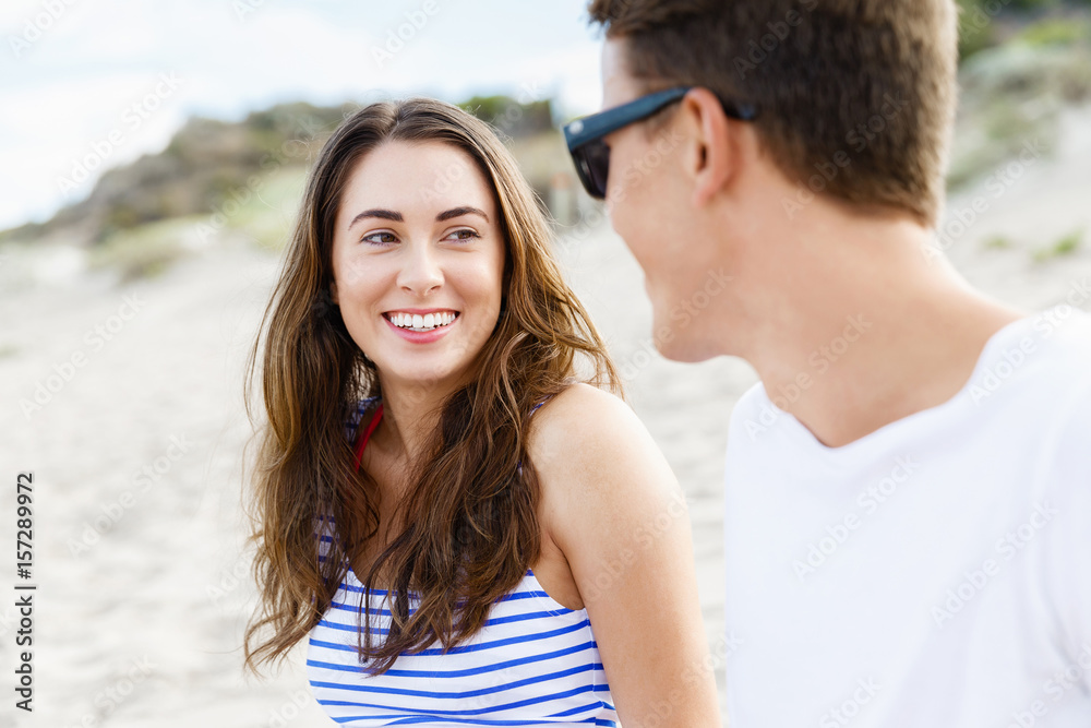 Romantic young couple sitting on the beach