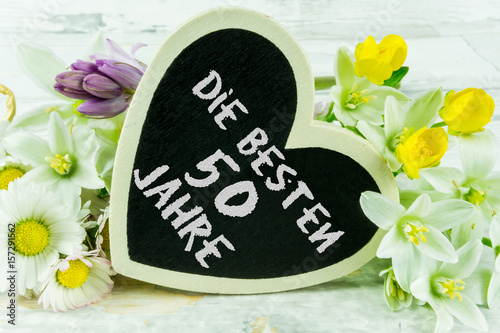 A colorful bouquet with a heart. With the text - Die besten 50 Jahre